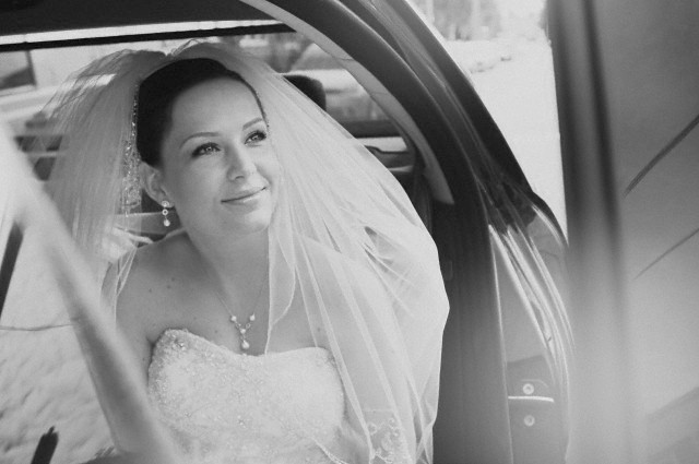 Bride exiting car --- Image by © Ben Hupfer/Corbis