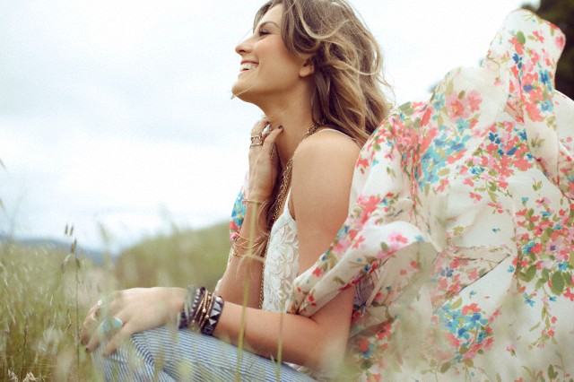 Woman sitting in grassy field